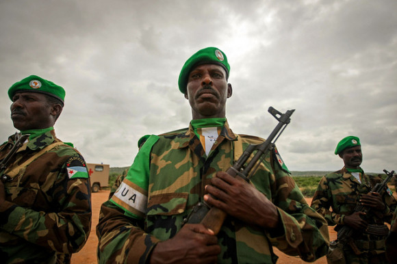 Soldiers of the Djiboutian Contingent serving with the African Union Mission in Somalia (AMISOM) stand to attention during the arrival of further troops to the central Somali town of Belet Weyne, 16 November 2012, approx. 300km north west of the Somali capital Mogadishu. The air lift is part of a deployment to begin boosting the just over 300 personnel already on the ground to approx. 1,000 troops serving under the UN-supported AU mission in Somalia. AU-UN IST PHOTO / STUART PRICE.