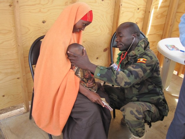 Capt Dr Patrick Kyambadde examining a patient at Baidoa OPD - AMISOM